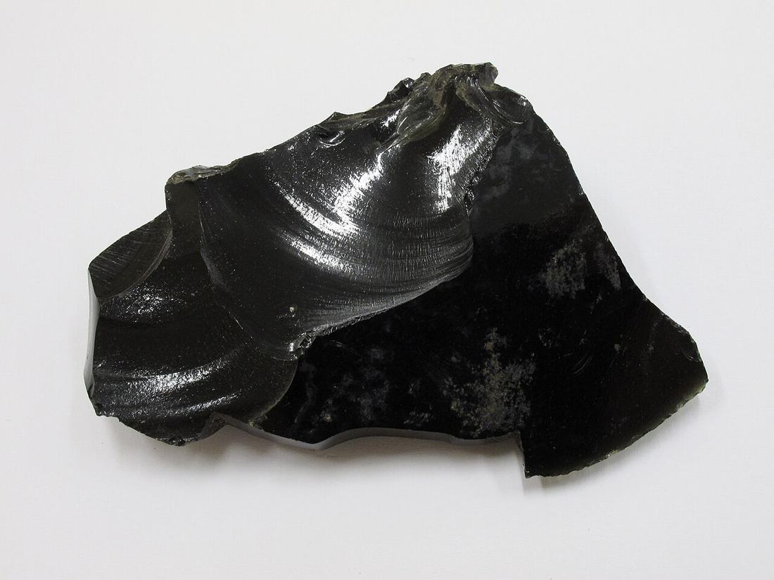 An obsidian flake in a museum collection